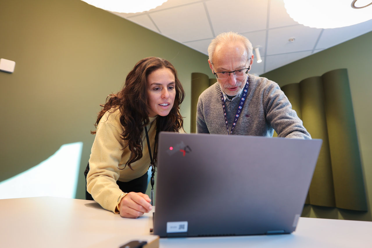 Man and woman looking at computer